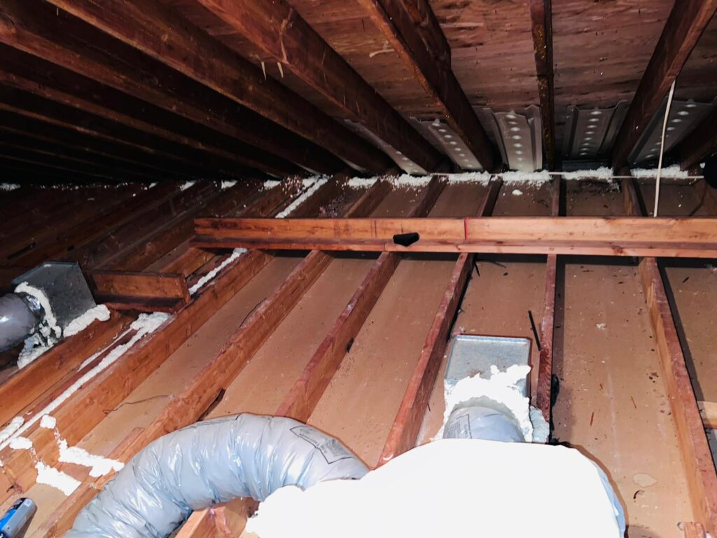 Spray Foam Insulation Services 3 Attic floor air sealing with spray foam around a bath fan duct and along the joist bays before insulation