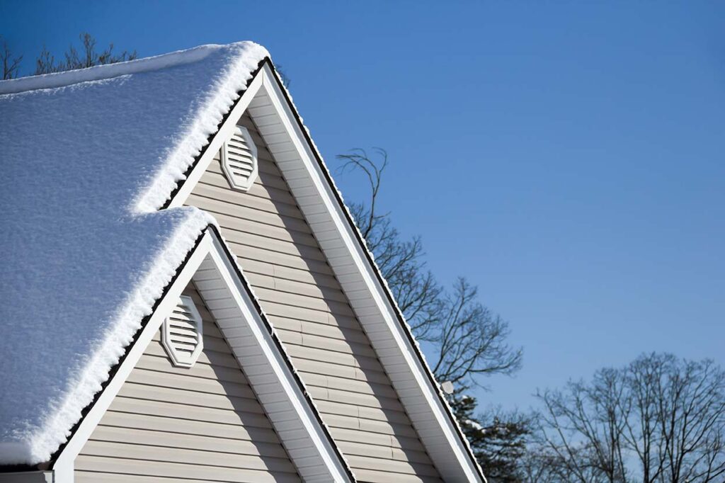 Snow on roof of house no ice dams due to properly insulated attic