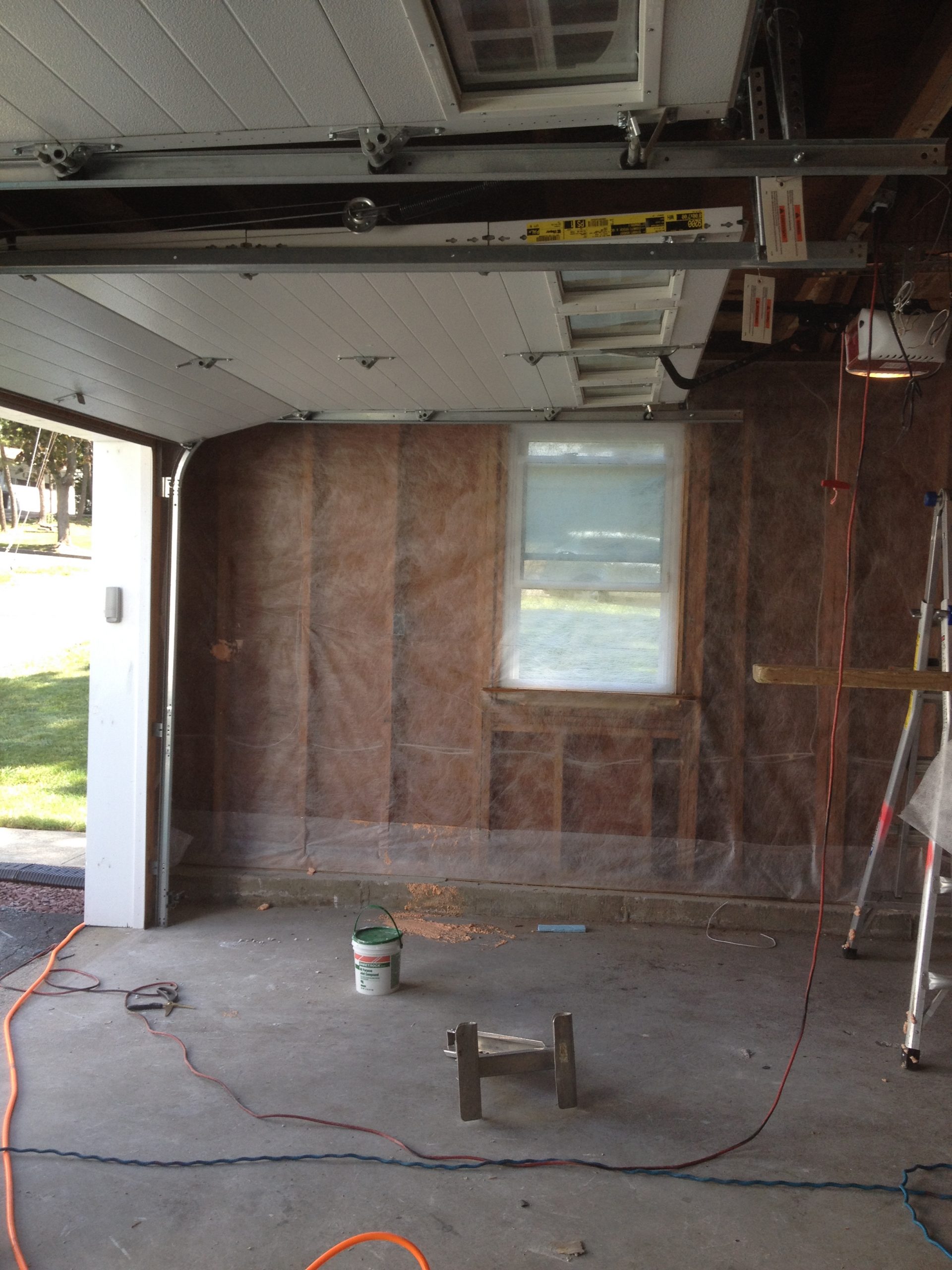 Insulation installed with protective netting before drywall — NJ garage renovation