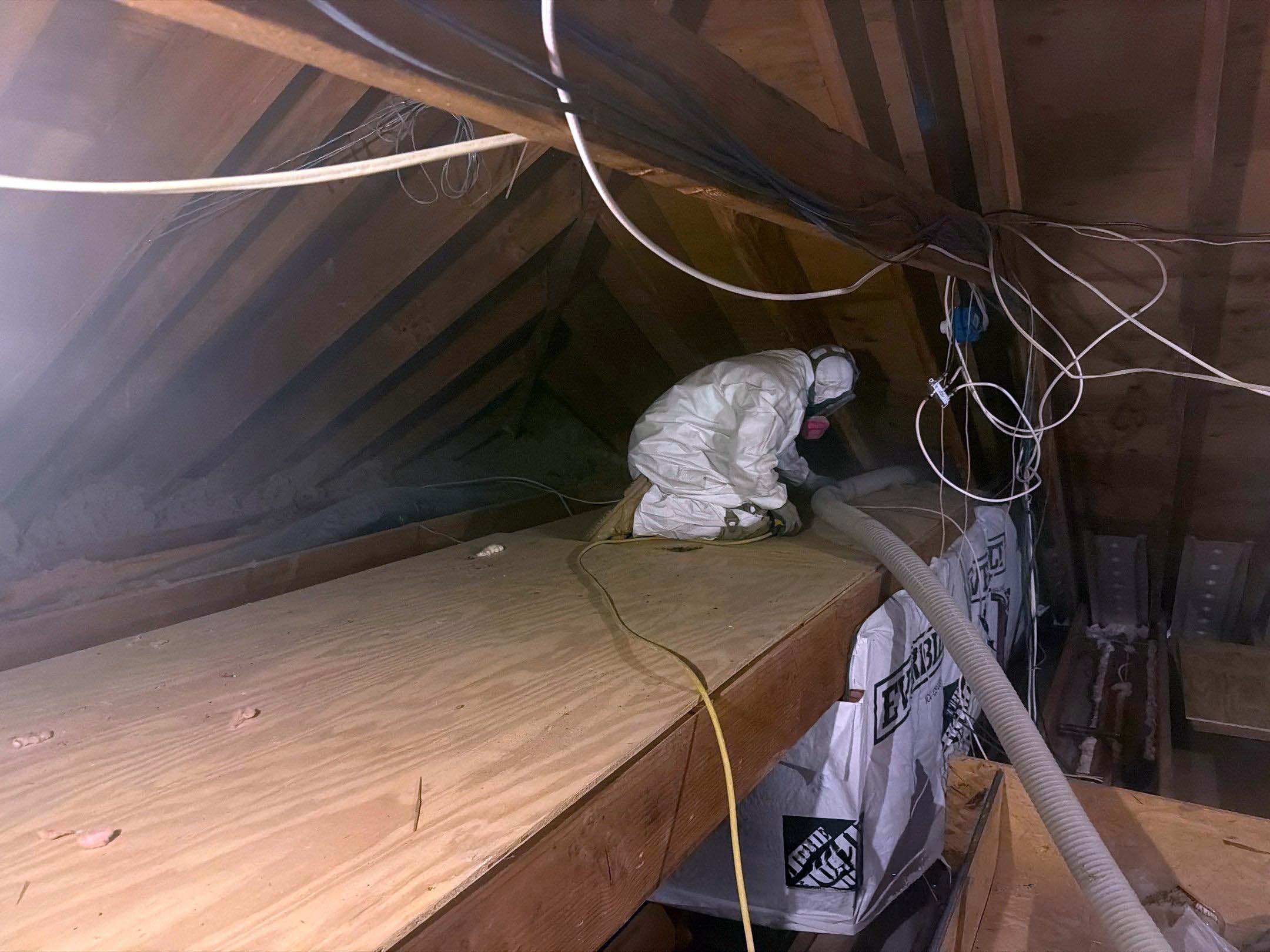 Metro NY Insulation technician installing insulation in Westchester NY attic