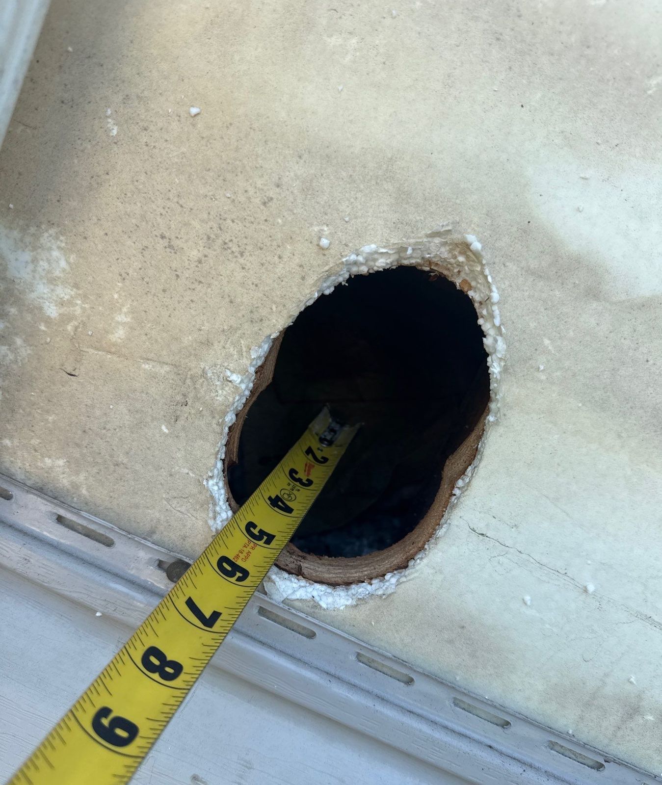 Exterior Dense Pack Cellulose Insulation Installation in White Plains, NY 6 Small drill-and-fill access hole in exterior wall sheathing measured for dense pack cellulose insulation, White Plains NY